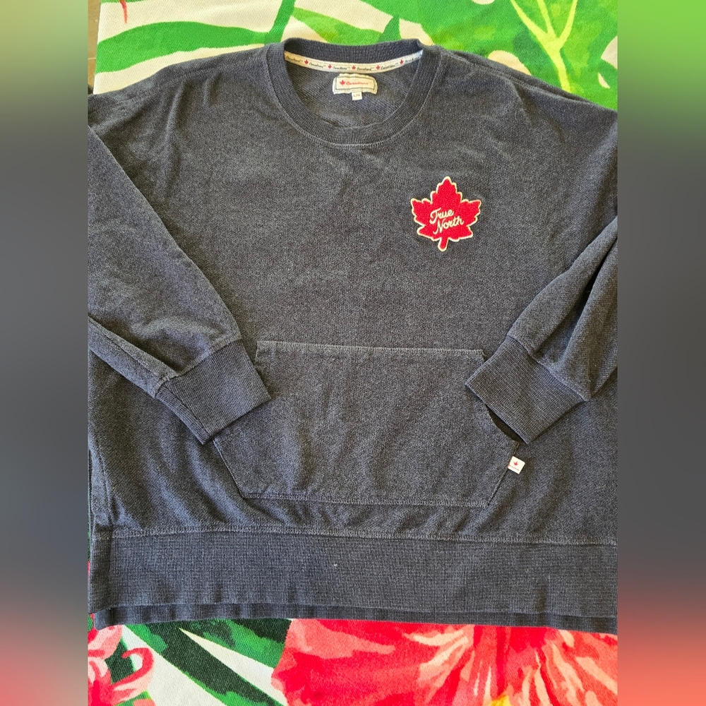 Canadiana pullover sweatshirt features a large red maple leaf patch.
